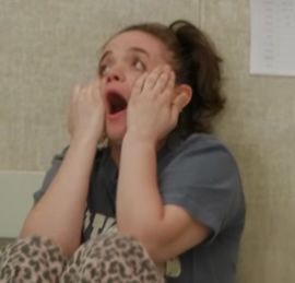 Angela grabbing her face in shock