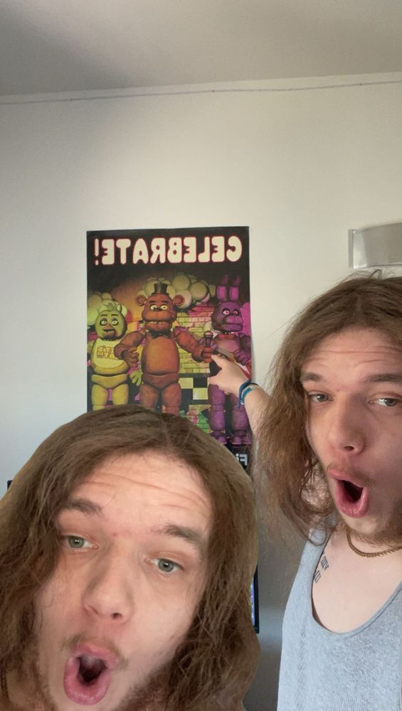 picture of the user recreating the soyjack pointing meme pointing towards a the fnaf 1 celebrate poster with the 3 main animatronics 
