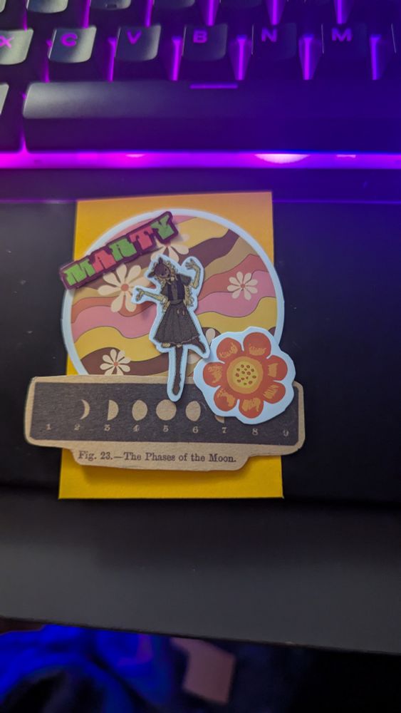 Loose stickers organized on an orange piece of cardstock.