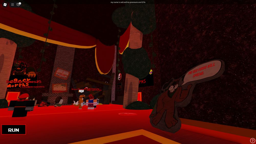 The lobby as viewed from the spawn hall, clearly in a serious state of destruction. On the right is the Bloodhound cutout normally near the legacy morph room, which now says "THE RED VIRUS WILL SPREAD."