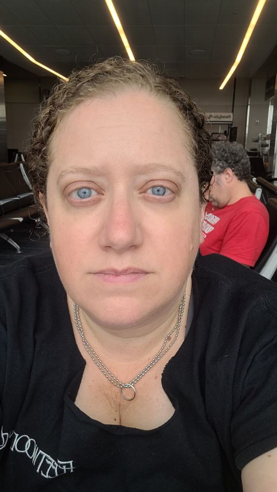 Tired woman who has spent the week working too much to go out on vacation while also getting herself and her kids ready to go on vacation 