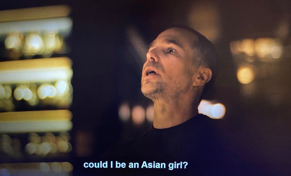 A still from The White Lotus in which actor Sam Rockwell recites a now infamous monologue detailing his journey to self-discovery, which involved him cos-playing as an Asian woman. 
