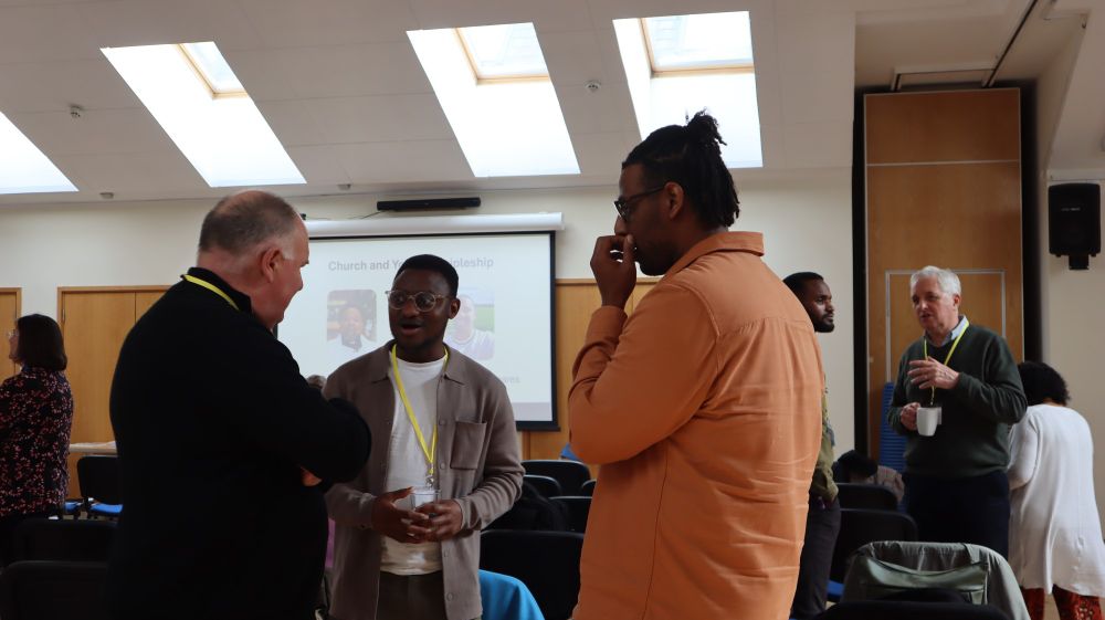 The Rt Reverend Neil Warwick, Bishop of Swindon (left) talking to conference attendees, including Pastor Jeronne Rudder (right)