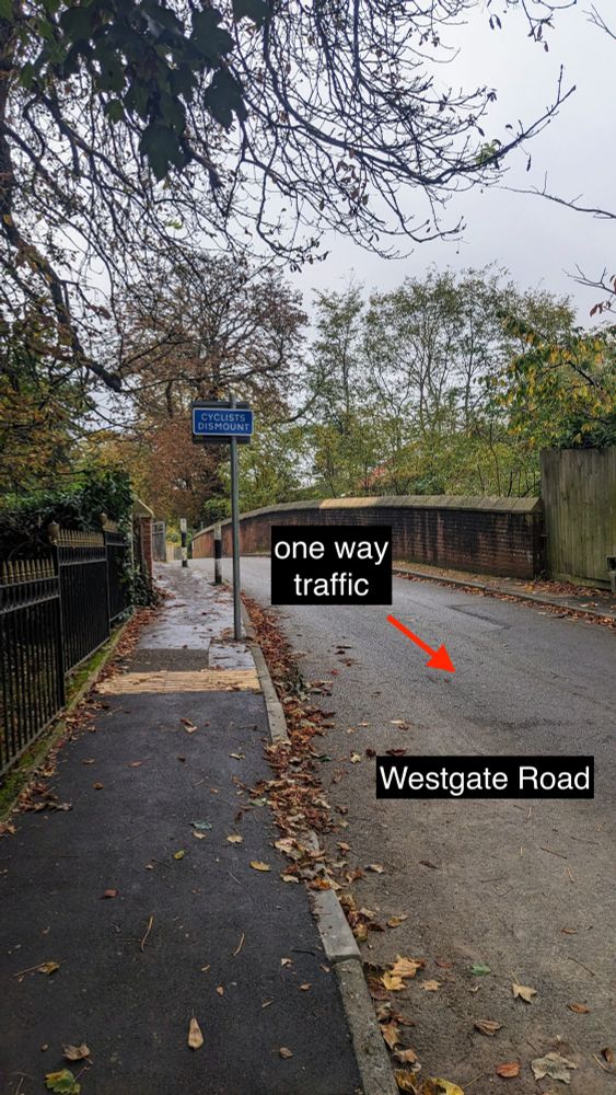 Photo of Westgate Road in Beckenham, showing the direction of one way traffic and a new sign reading 'Cyclists dismount'