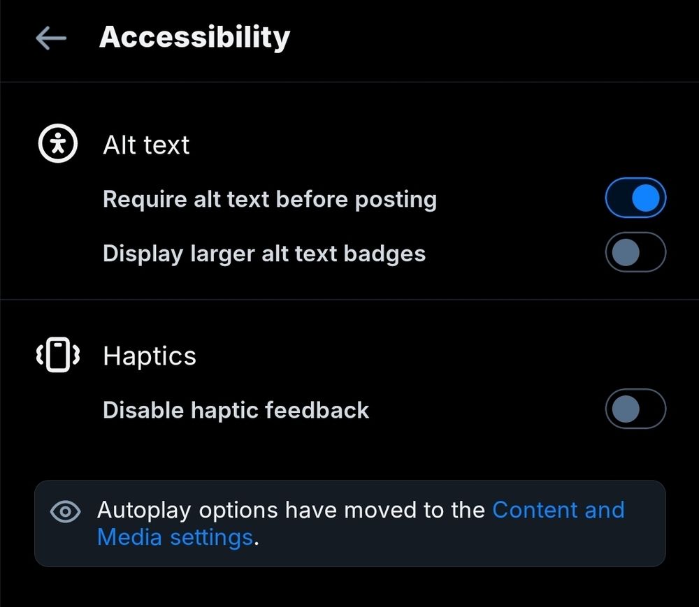 Dark mode screenshot of Bluesky's Accessibility menu. Under "Alt text", the option "Require alt text before posting" is toggled on and "Display larger alt text badges" is toggled off. Under the "Haptics" heading, "Disable haptic feedback" is toggled off. At the bottom is a notice reading "Autoplay options have moved to the Content and Media settings".