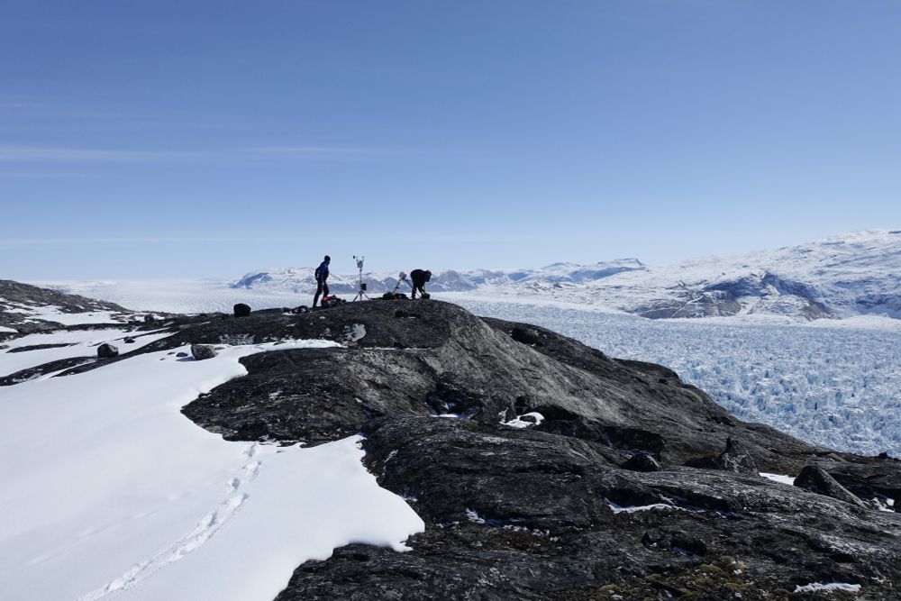 Picture of me and David Ashmore installing a weather station and time lapse camera next to a marine terminating glacier in Greenland 