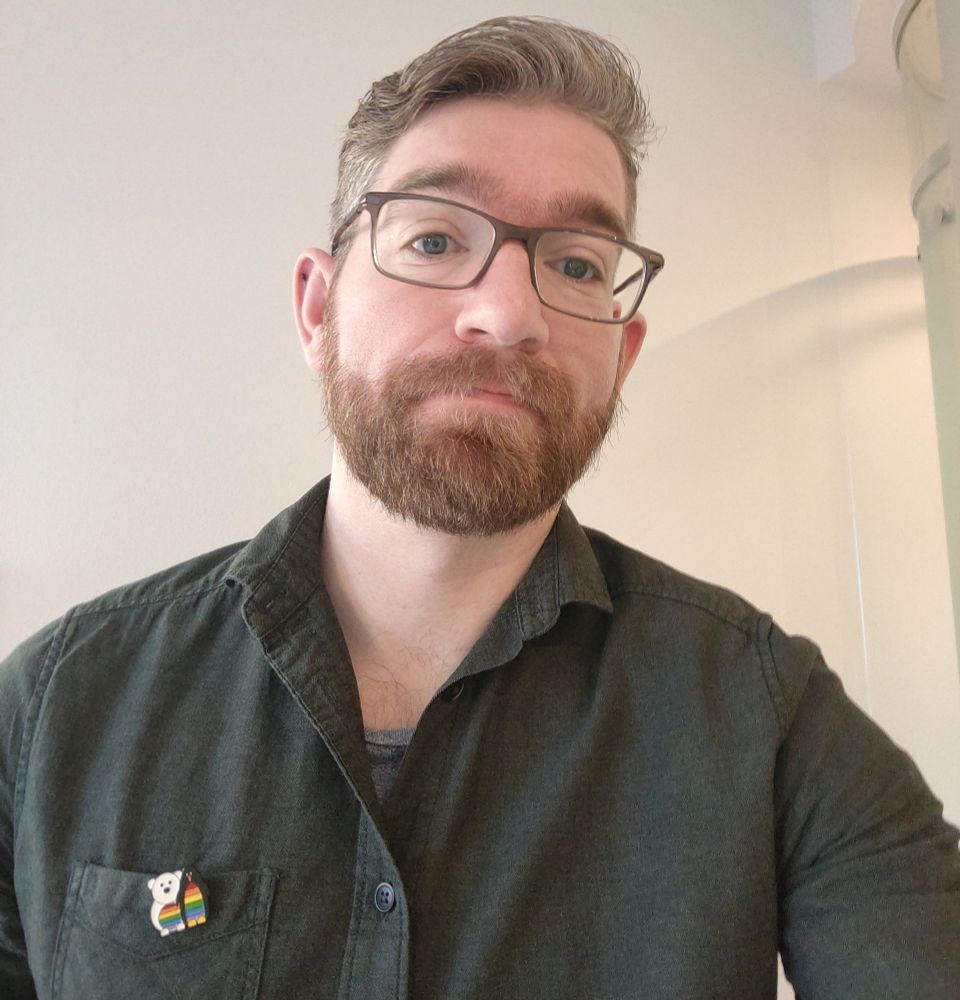 Selfie of me wearing Polar Pride pin badge