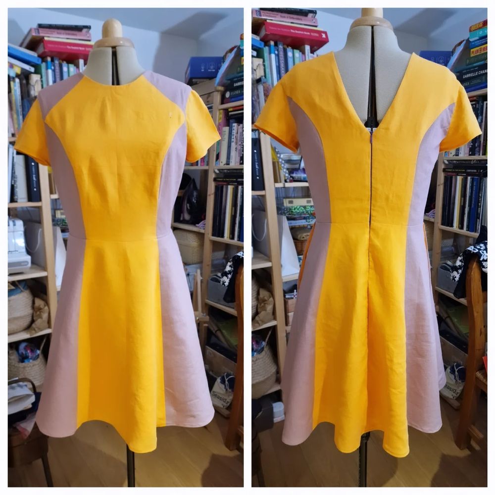 Picture shows a collage of a dress on a form. The left side shows the front with an orange centre panel, with purple sides.

The right side shows the back with a v neck drop purple zip and orange centre panel again
