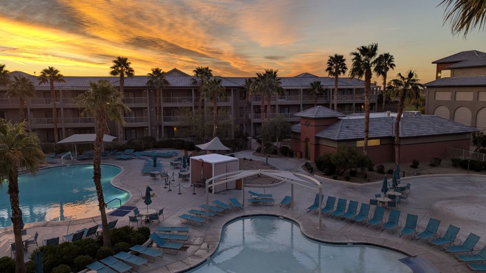 Sunrise with Palm trees and pools.
