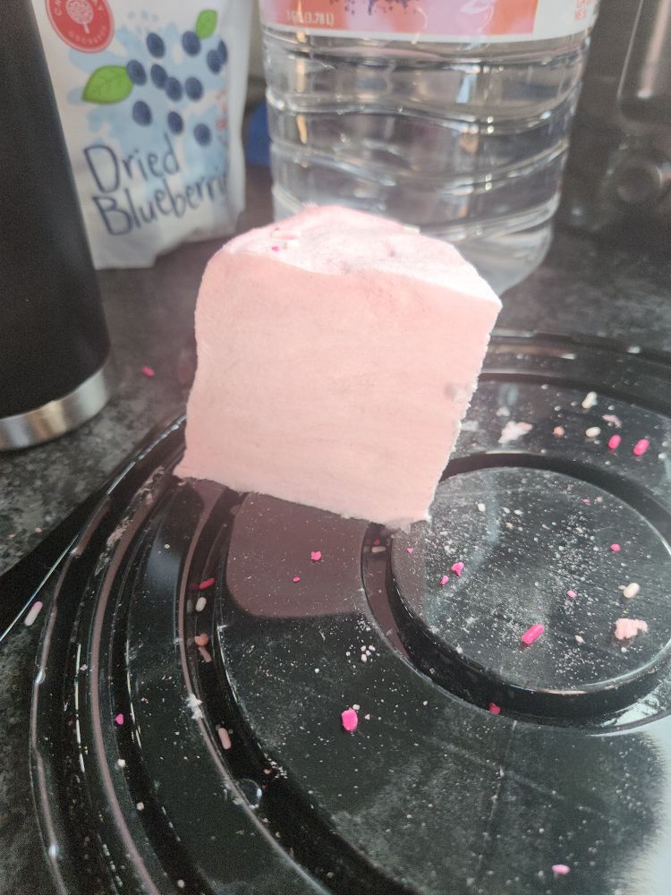 Last slice of pink cotton candy cake on a plate.
