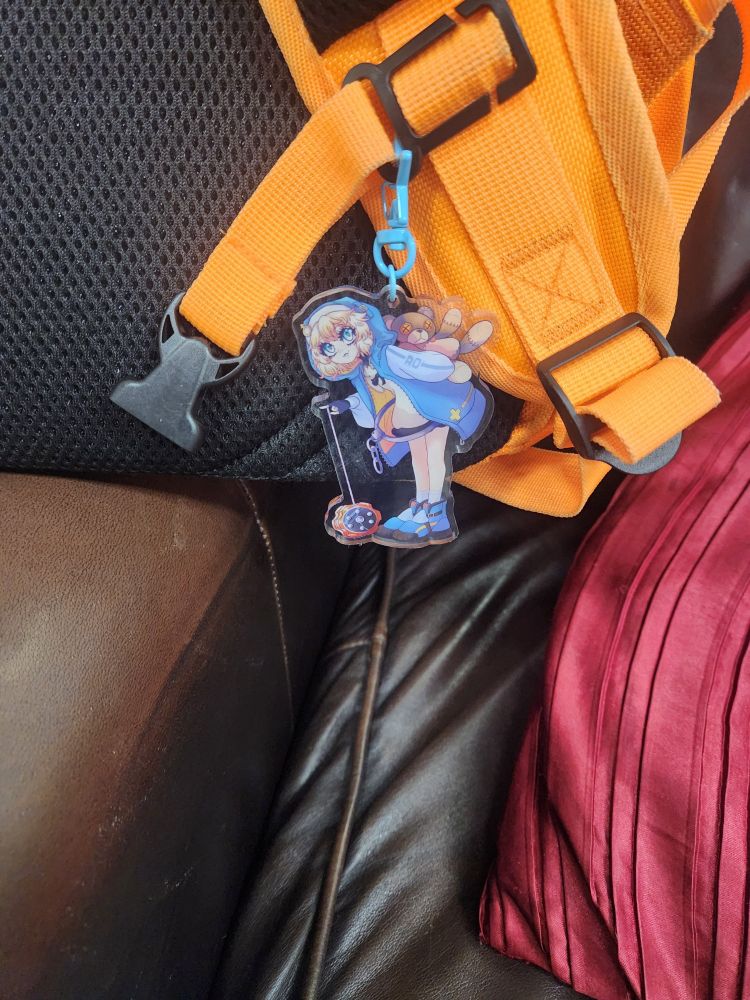Backpack with an Bridget from Guilty Gear keychains on it 