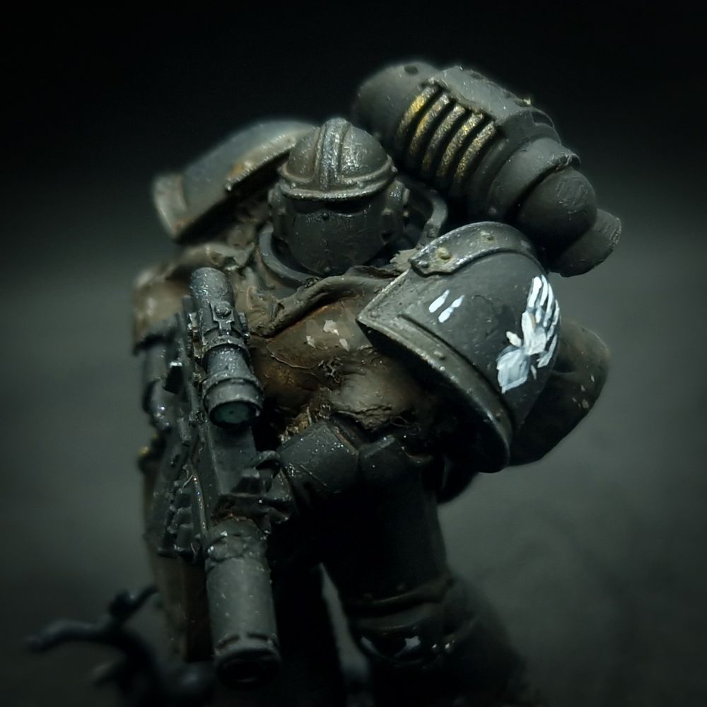 Mark 3 Space Marine from the Iron Hands Legion, armed with a Nemesis Bolter and wearing a camo cloak.