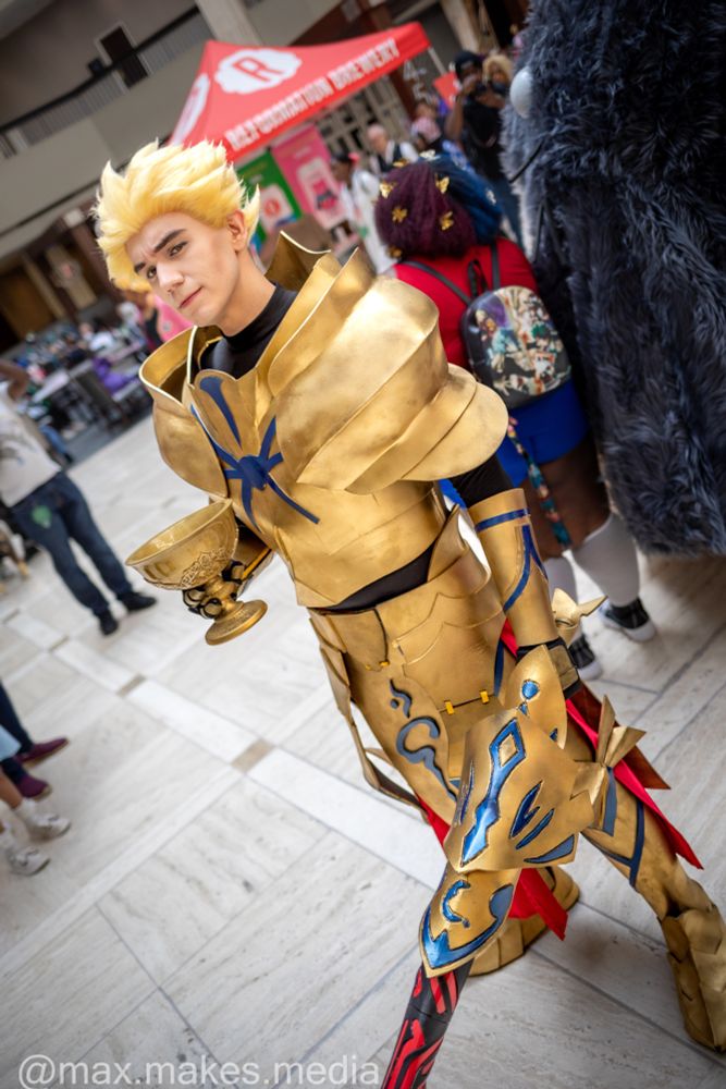 Gilgamesh from FGO holding the holy grail and EA at Anime Weekend Atlanta