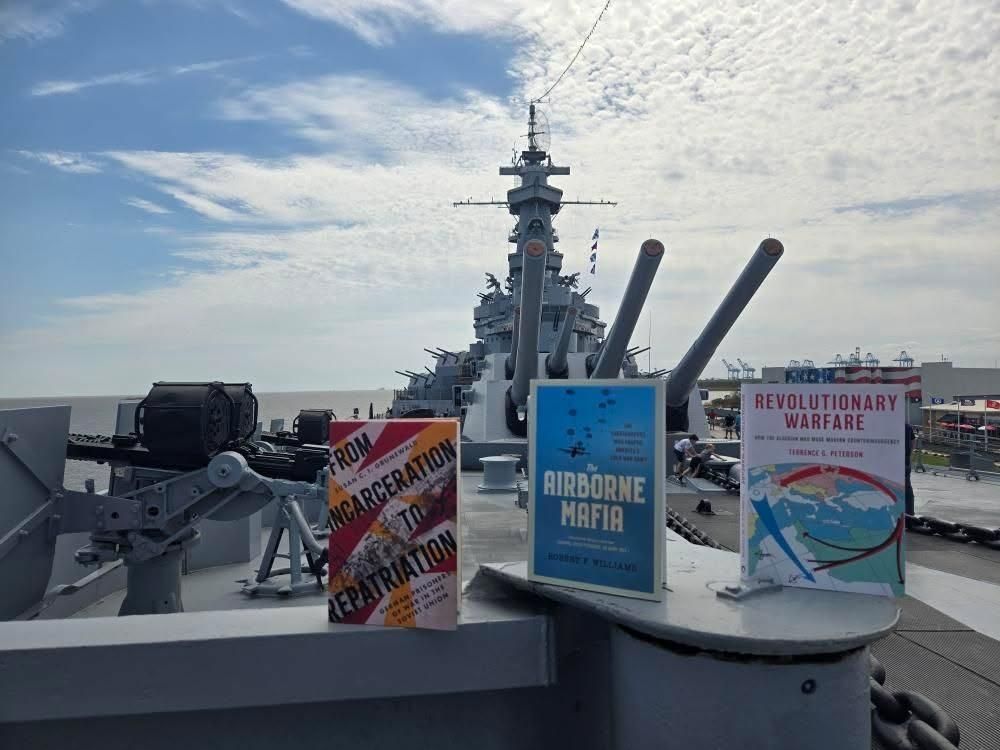 Three awesome books posed on a gunboat