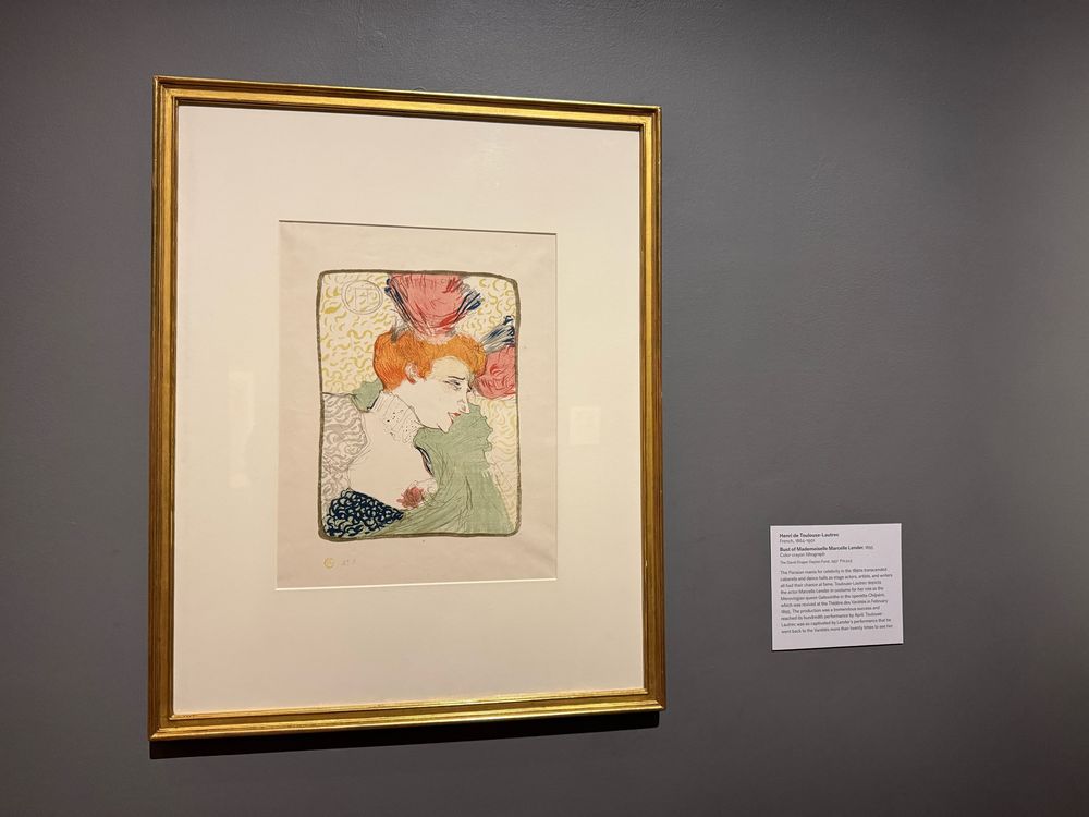 A color crayon lithograph of Bust of Mademoiselle Marcelle Lender, with thin gold frame and white informational note card. 