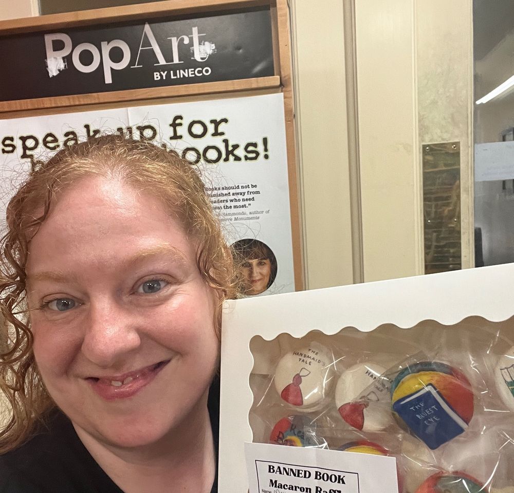 Bookseller Bethany shows off a box of macarons from Sara
