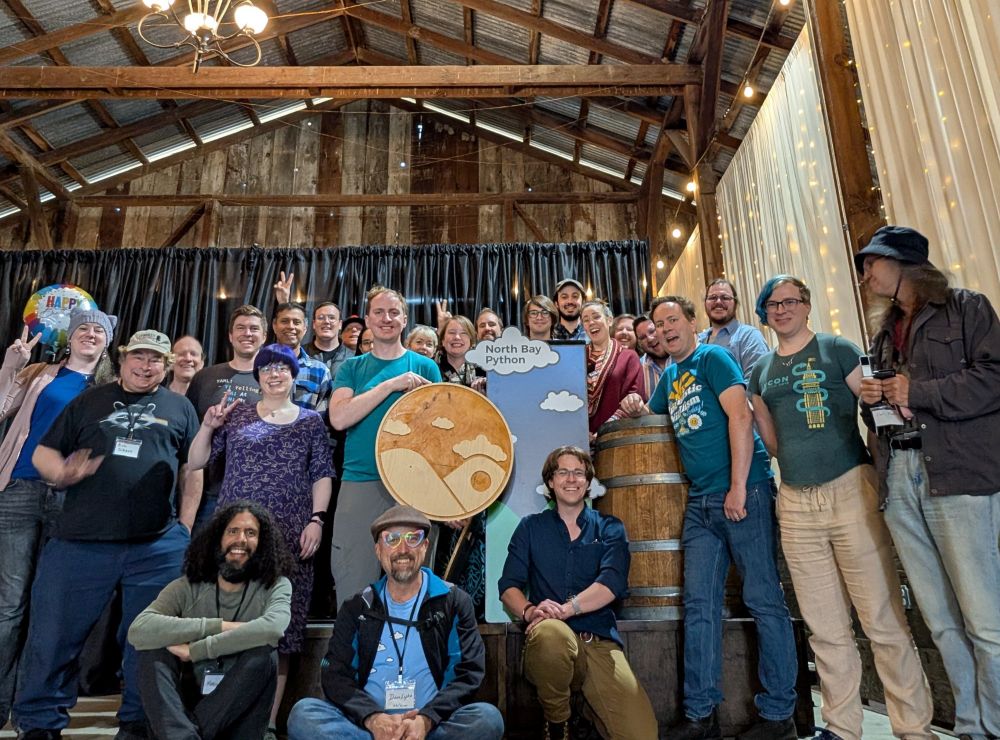 A group photo of everyone who helped strike the venue gathered around the brightly colored lectern front.