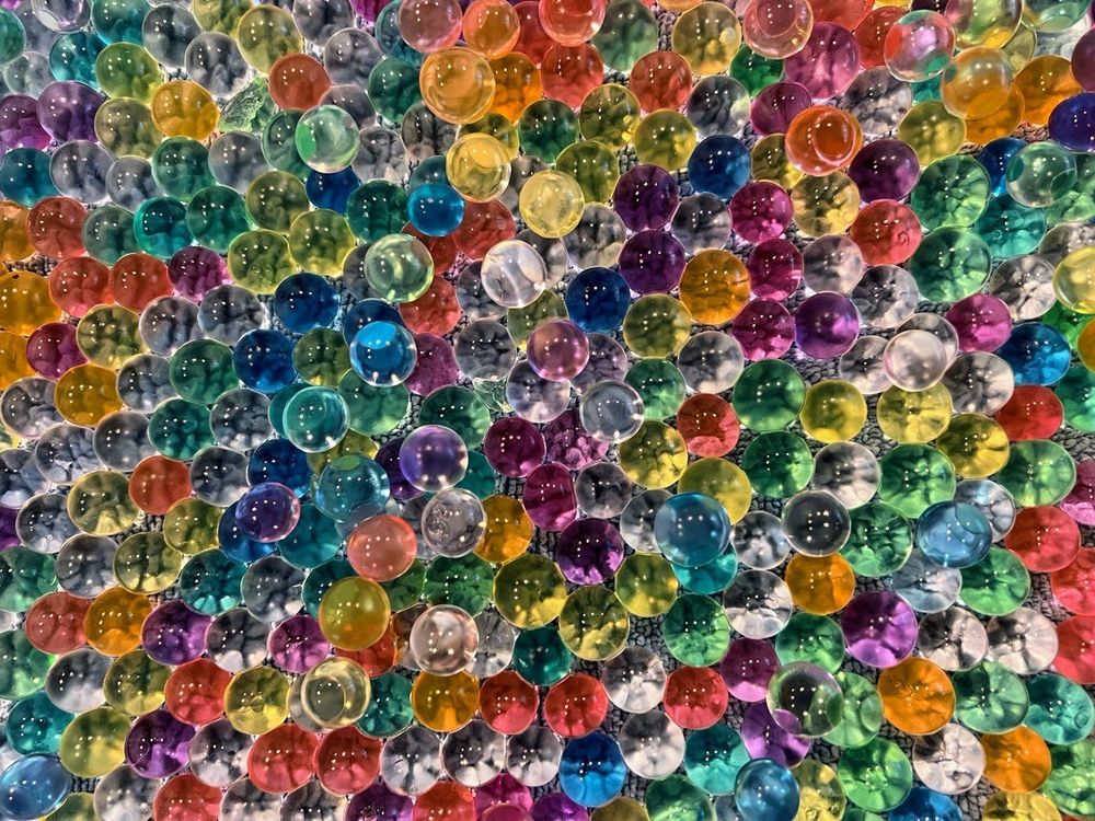 A tray full of colorful water beads