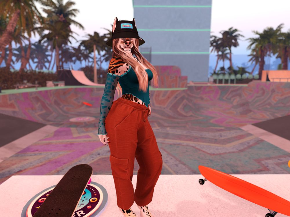 Anthro ocelot with long hair, heart shaped glasses, a bucket hat, teal top, and orange cargo pants stands in a skate park with palm trees in the background. 