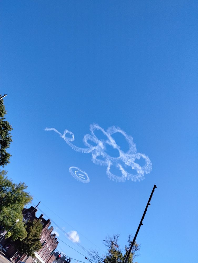Skywriting of a daisy and a smiley face