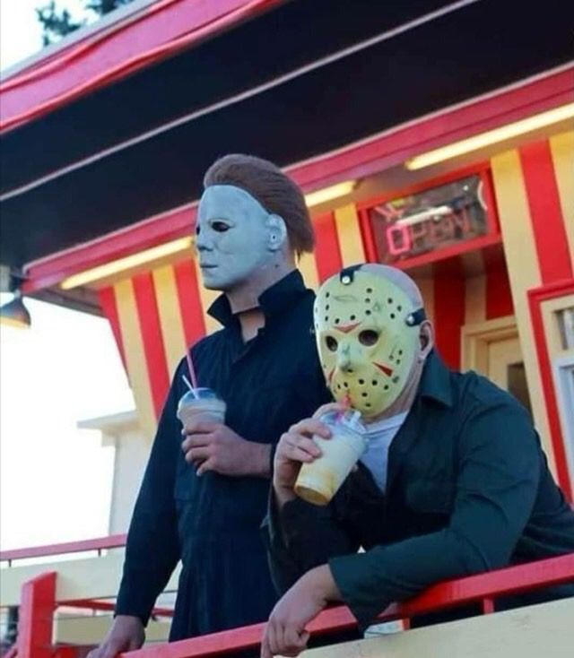 Michael Myers and Jason Voorhees are drinking beverages together in a casual moment. 