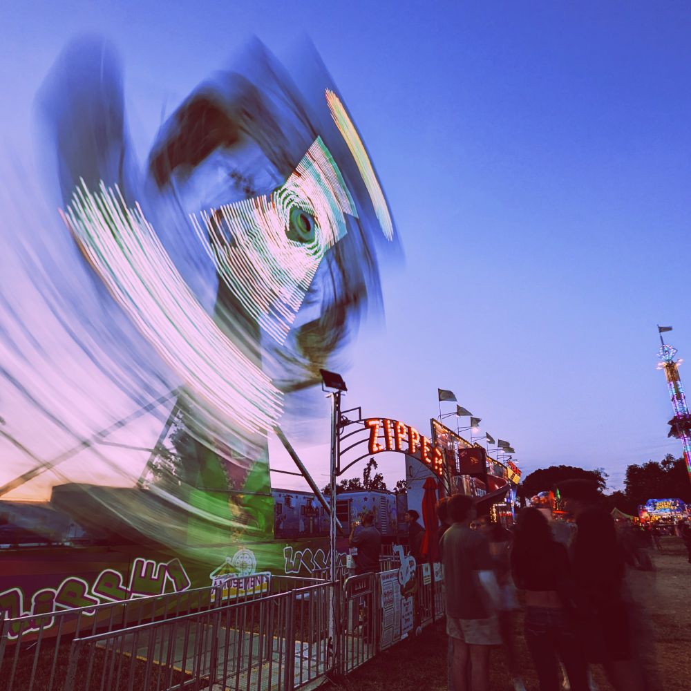 They say that diagonal lines convey a sense of dynamism so I took yet another photograph of Zipper, this time at a low angle as the rides main arm extends from lower left towards the center top.