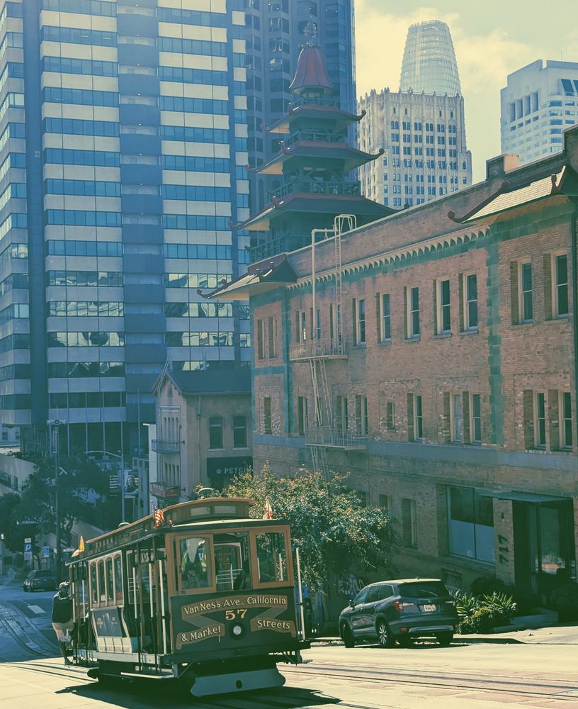 Cable Car 57 rushes up California Street next to the Sing Fat pagoda roofs, now overwhelmed by neighboring skyscrapers from the Financial District.
