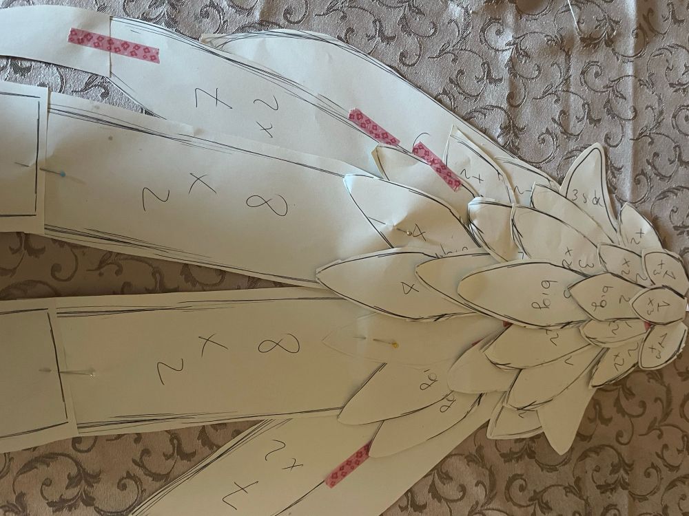 paper shapes that will be used to model her tail