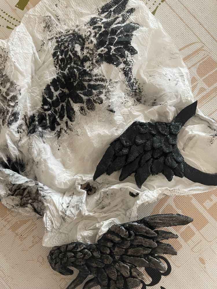 the wing shaped parts of meteion’s brooch, mid-painting