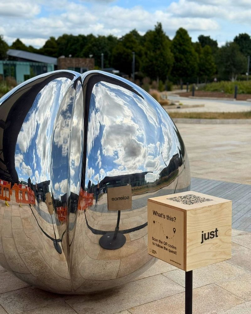 the just good science quest box in front of the giant silver ball