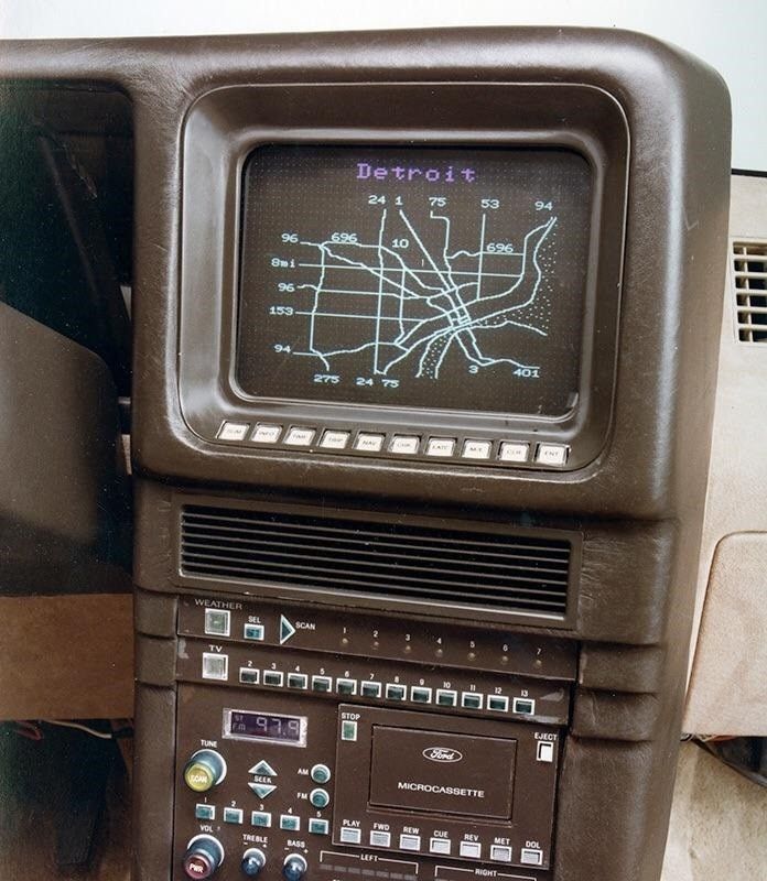 A photo of a very early 80s piece of tech in chocolate brown leather and plastic with all kinds of buttons and dials on it and a vector graphic route map that gives it a very Fallout-ish tech vibe.