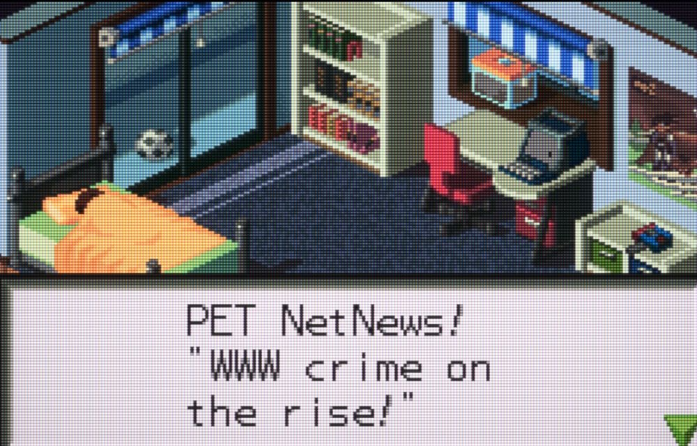 A snap from Mega Man Battle Network's opening scene in  Lan's bedroom with "PET NetNews! WWW crime on the rise!" in a dialogue box