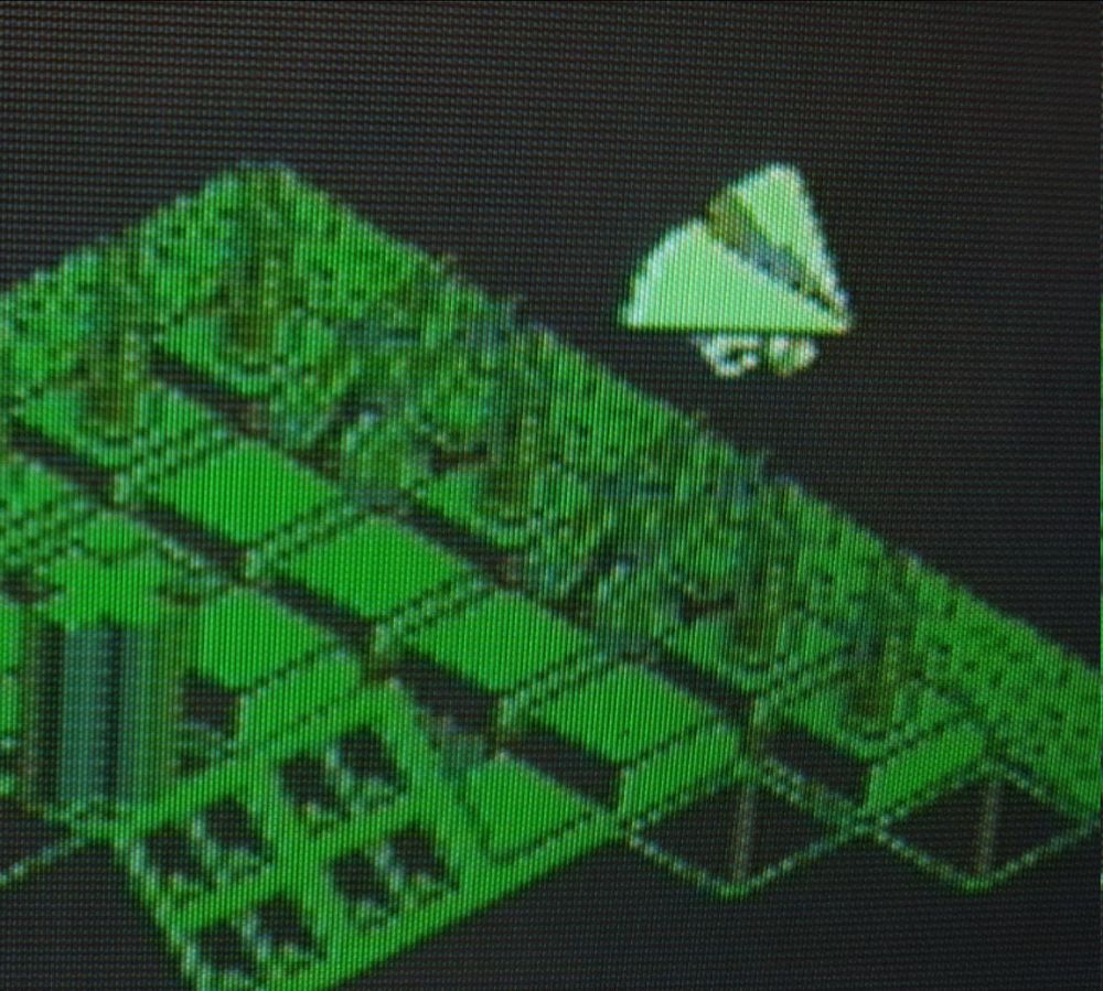 A close-up of the glider sprite flying over facilities and defences.