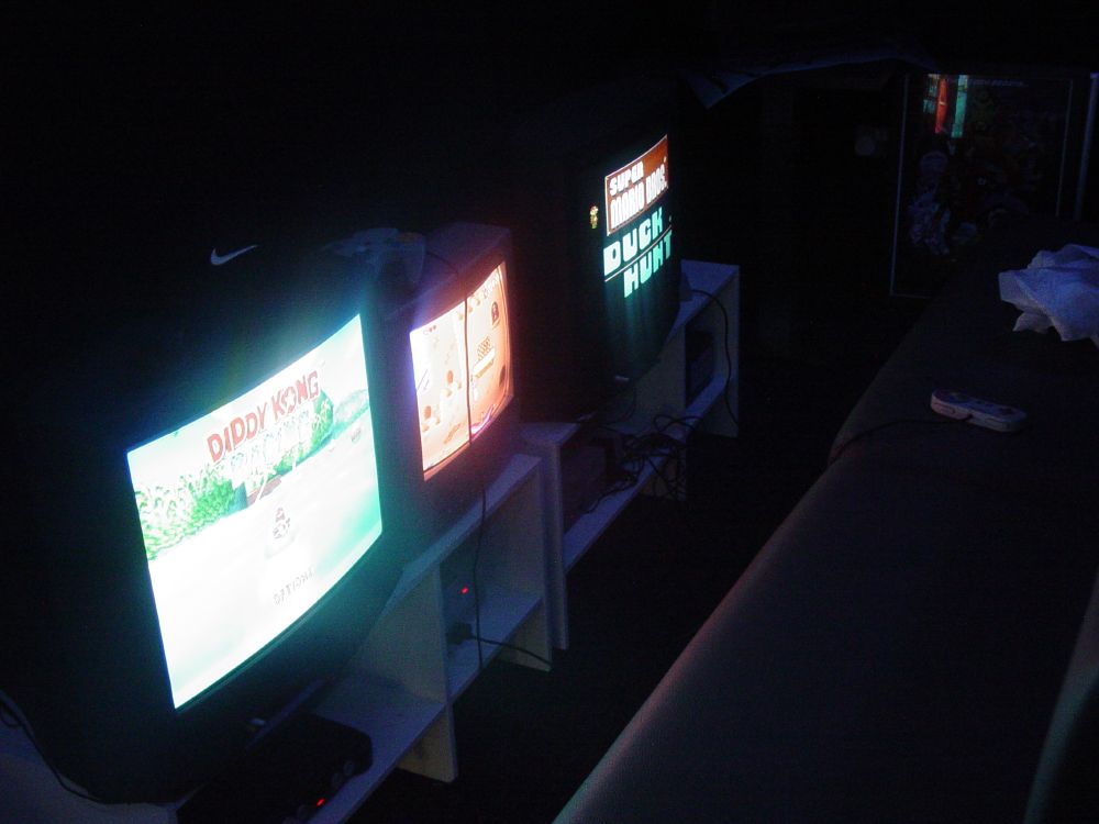 The retro consoles room with an N64, NES, and SNES, crt screens glowing