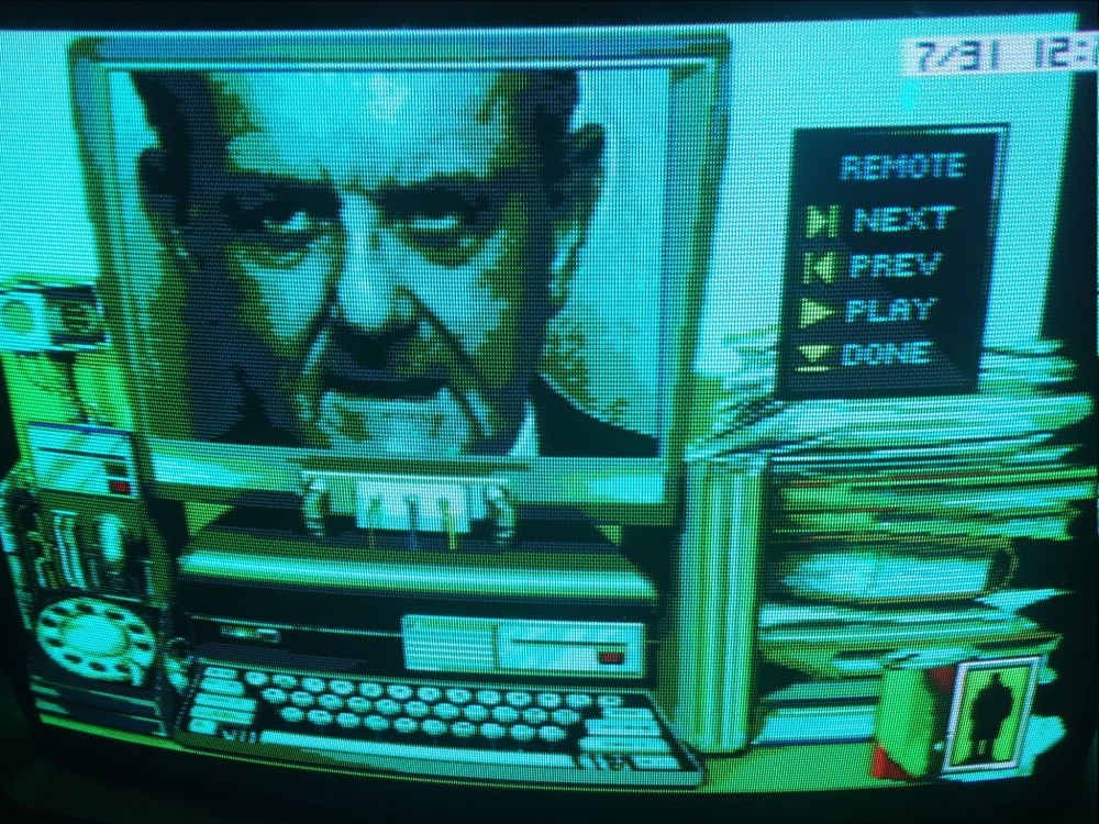 The amazingly analogue/digital fusion terminal with a tactile keyboard, rotary telephone and flat screen display above a narrow base unit. A digitized older guy's face is on he screen