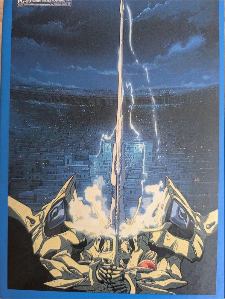 The back of the box with a gorgeous illustration of the Escaflowne mech and a cloudy blue-black sky