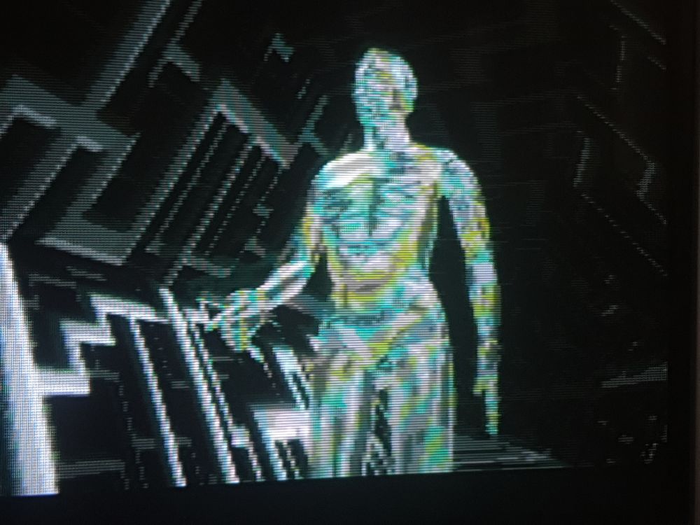 A grainy render of a cyberspace glowy blue avatar striding along a techie corridor 