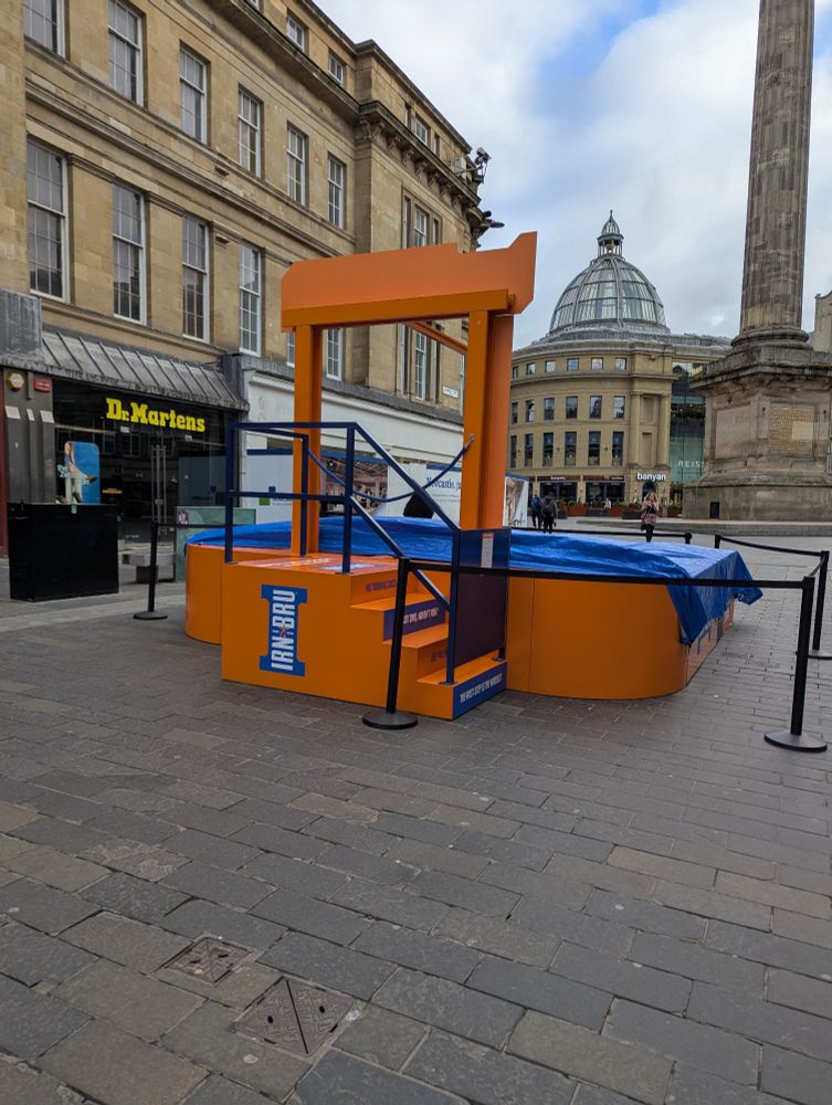 strange promotional apparatus for Irn Bru, set up on a city street. It looks a bit like a squat guillotine 