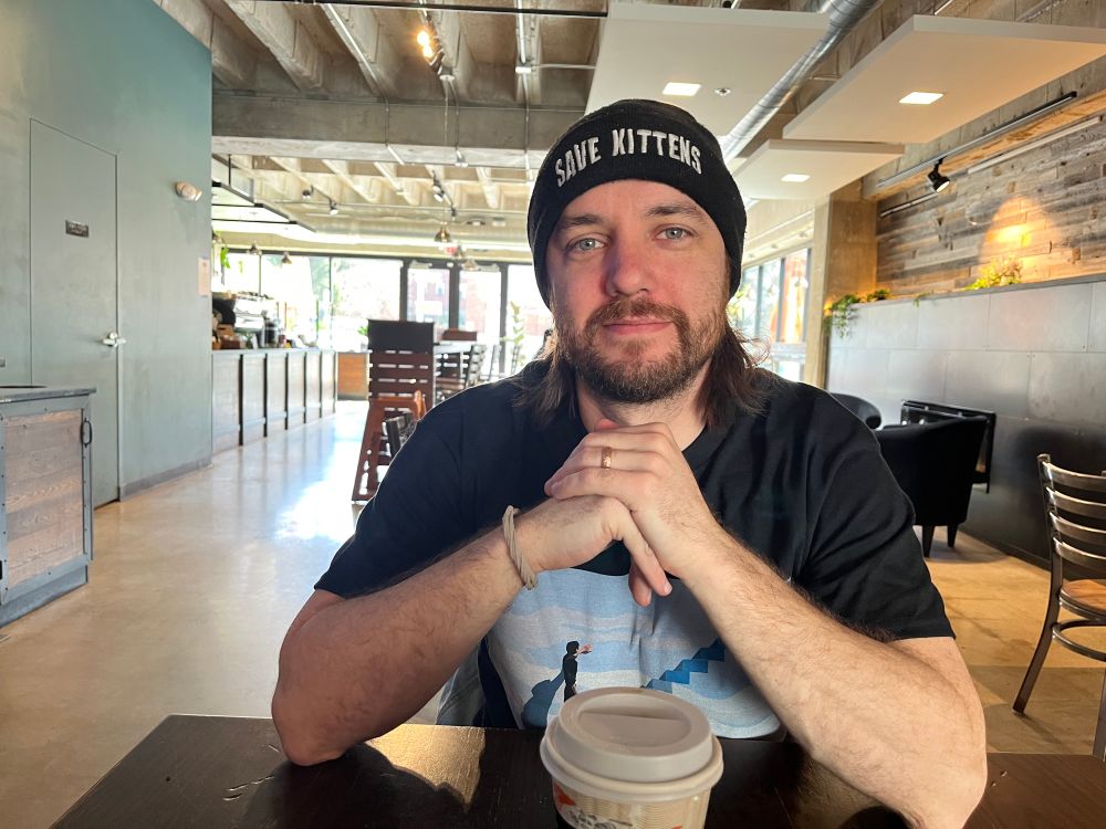 me, in a long, sunny coffee shop, sitting across a table from my wife 