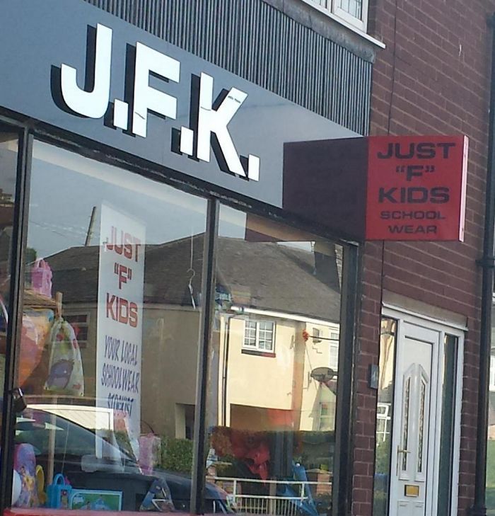 J.F.K. on a storefront 2 signs say Just 