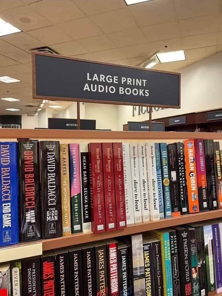 a bookshelf with "books" on it and the sign says 'LARGE PRINT AUDIO BOOKS"