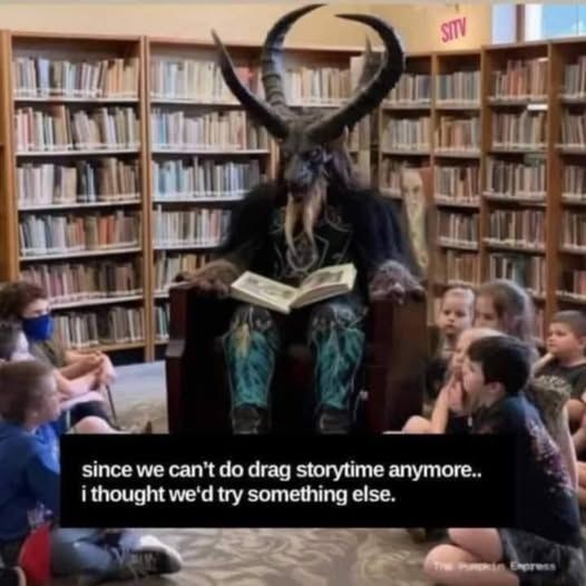 Cloven Hooved Horned Satan sitting in a library reading books to kids   since we can't do drag storytime anymore....i thought we'd try something else