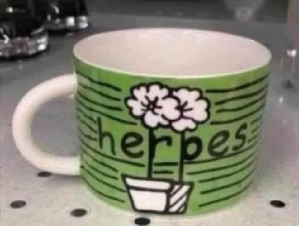 cup looks like it says herpes but says heroes and flowers mess it up