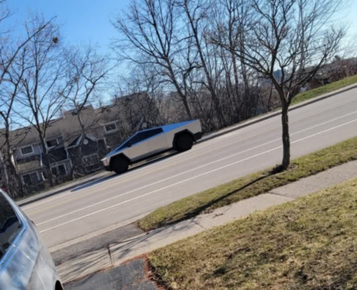 a cybertruck parked across the street