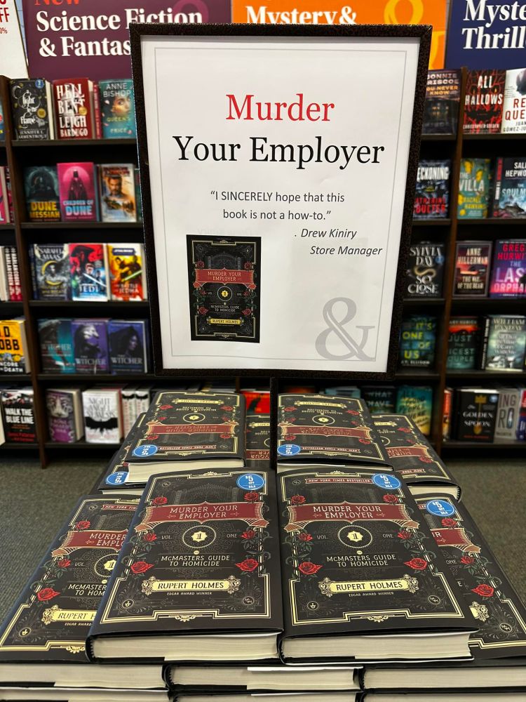 a book display in a book store that says 'murder your employer - "i sincerely hope that this book is not a how-to." ~Drew Inity - store manager
