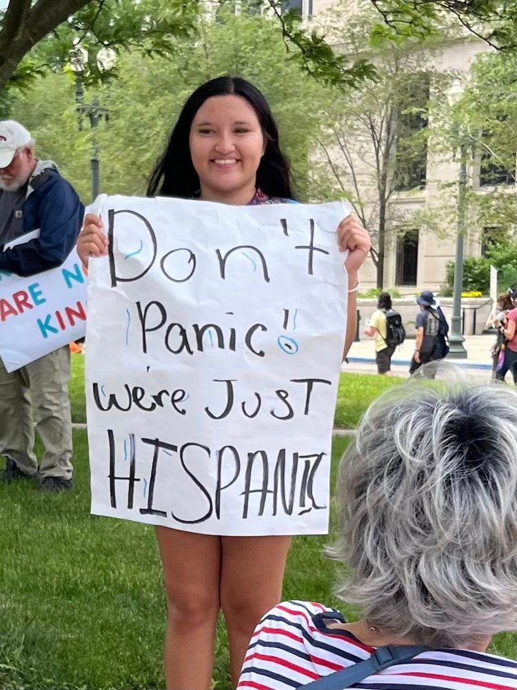 a protest sign don't panic, we're just hispanic