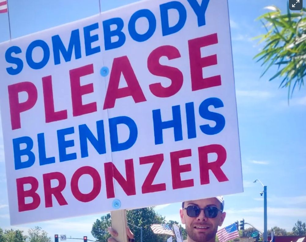 a protest sign that says somebody please blend his bronzer