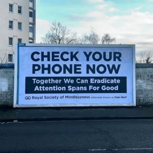 a sign that says 'check your phone now - together we can eradicate attention spans]