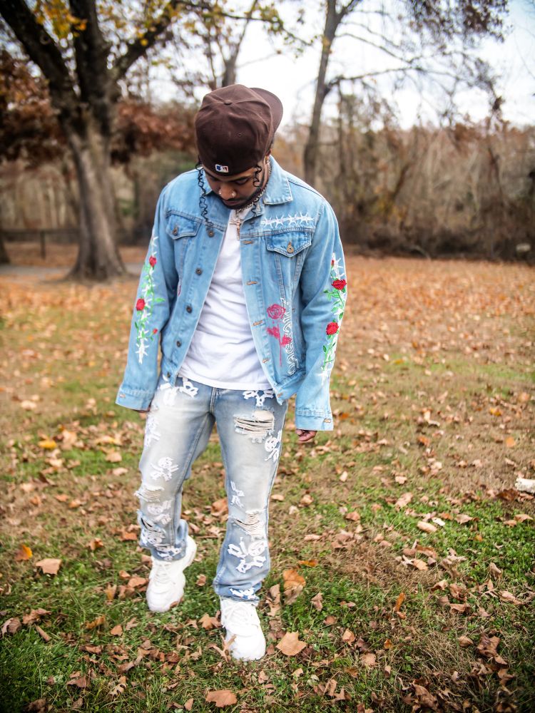 Famous rapper , dance & professional videographer taking a professional picture in the open. Dressing in fashion with nice jean on jean outfit. 