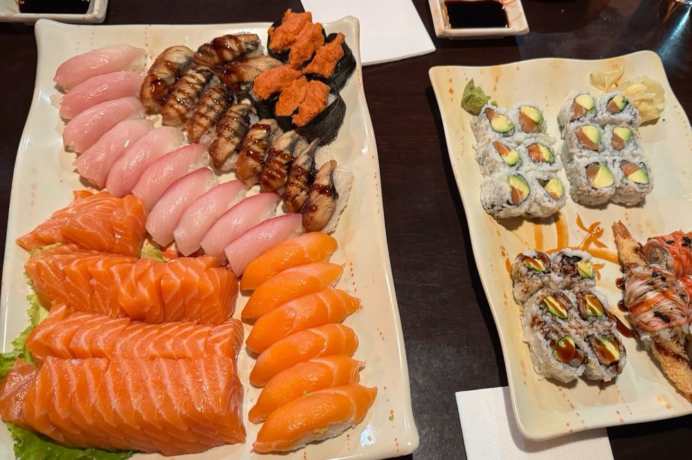 ~30 Salmon sashimi, 10 yellowtail nigiri, 6 salmon nigiri, 10 unagi sashimi, and 6 spicy salmon nigiri on the left plate. 2 salmon avocado rolls, 1 unagi avocado roll, and 1 special roll on the right plate 